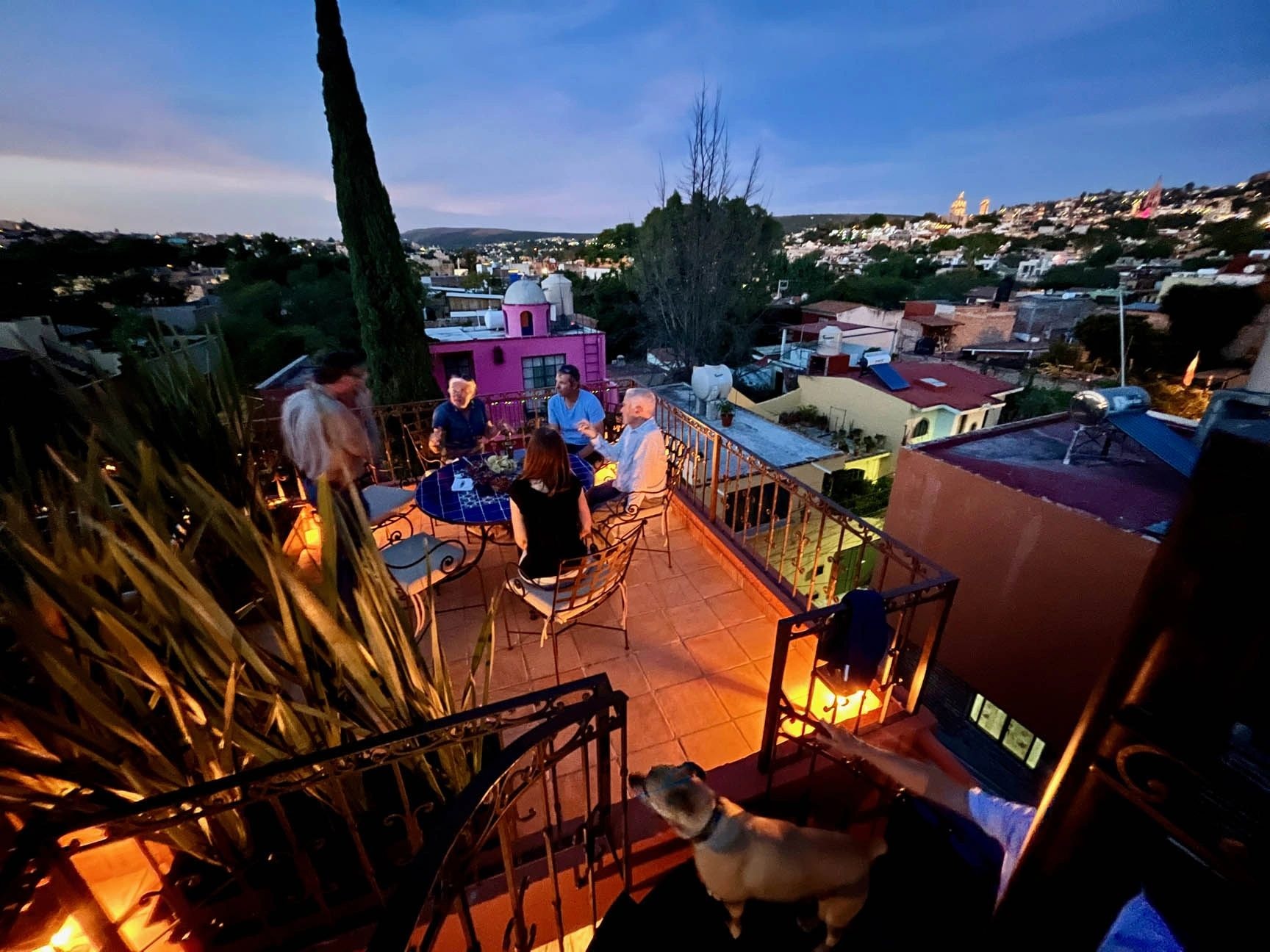 Rooftop terrace at dusk with city views